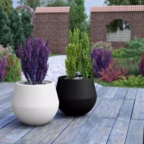 Biała i czarna donica Aurora w ogrodzie